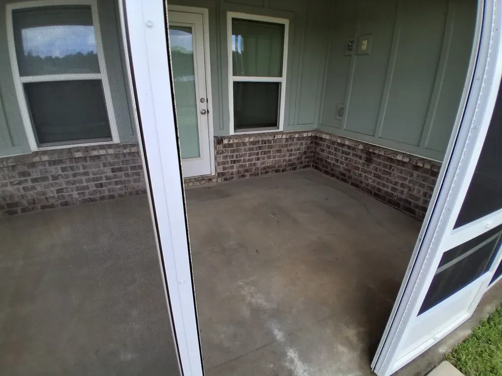 Screened porch with brick skirt and glass door, finished view
